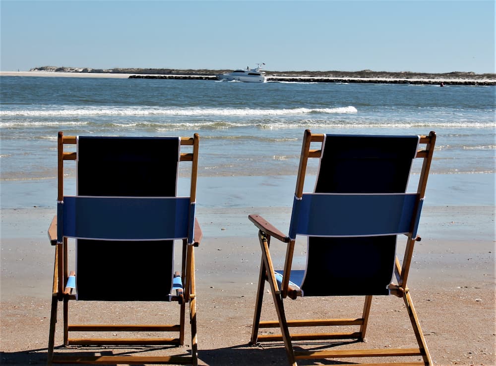 2 deck chairs facing the ocean