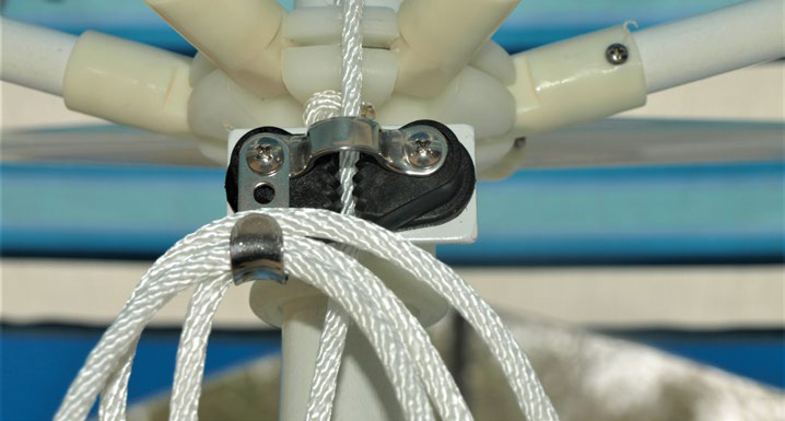 An umbrella drawstring pulled through the auto-lock pulley