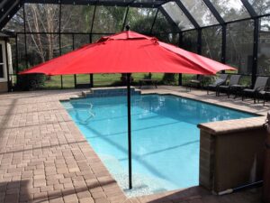 red umbrella in pool alone