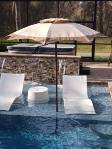 Khaki Catalina in pool with shelf loungers underneath
