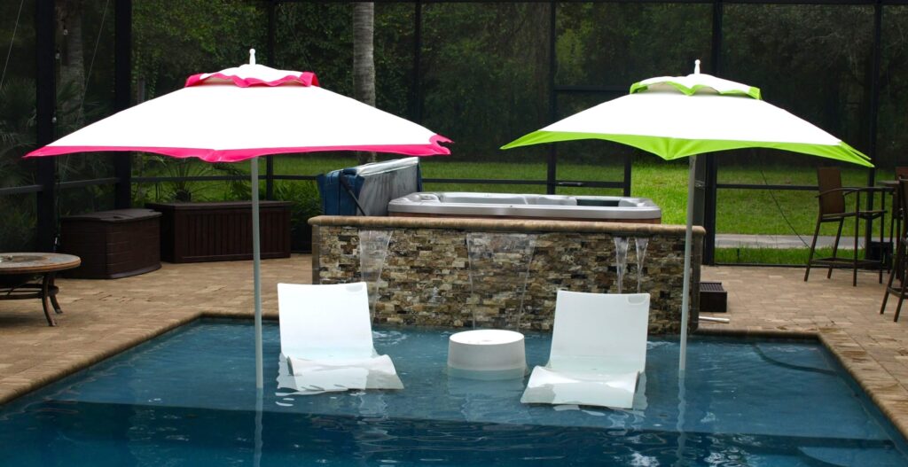 Pink and green catalina in pool with shelf loungers and table