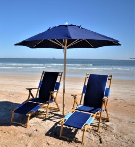 blue umbrella on beach with beach chairs underneath