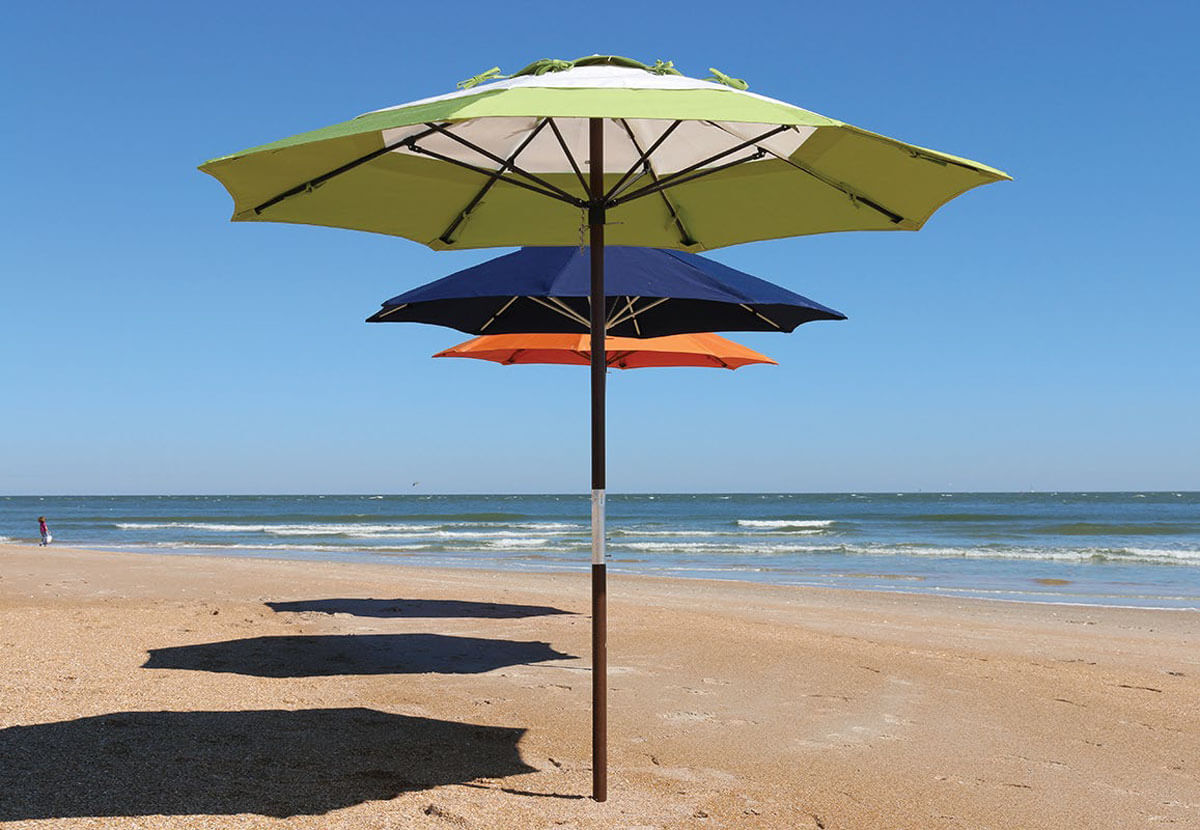 row of beach umbrellas on beach